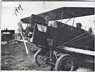 A biplane at rest on a grass field, 1929